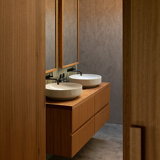 Interior photograph of Bayview Tree House by As shown in the bathroom, the materials used are responsive to context and climate. Photographer: Luke Shadbolt