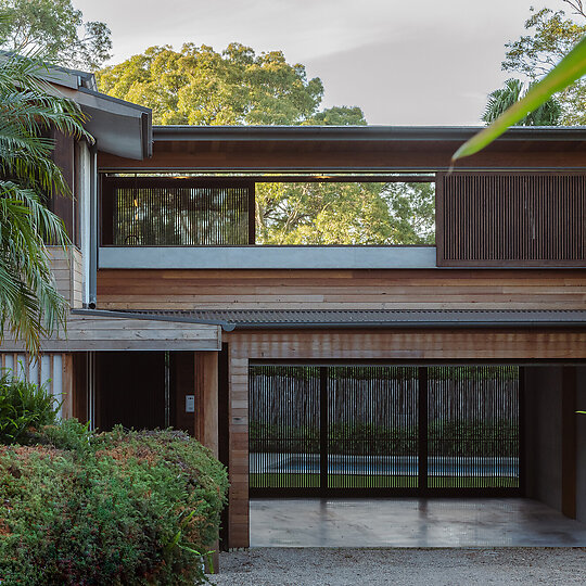 Interior photograph of Bayview Tree House by The de-cluttered  garage can now be used as a shaded outdoor area for gatherings and children playing at garden level. Photographer: Luke Shadbolt