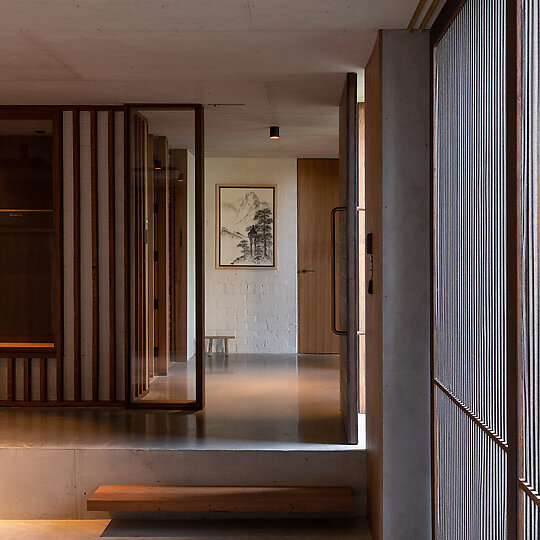 Interior photograph of Bayview Tree House by Materials such as recycled hardwood and exposed steelwork are used in cohesion with the existing brickwork. Photographer: Luke Shadbolt