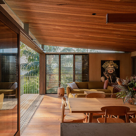 Interior photograph of Bayview Tree House by Visually sensitive to the surrounding bushland, the architecture uses rustic materials. Artwork by Alina Dalinina. Photographer: Luke Shadbolt