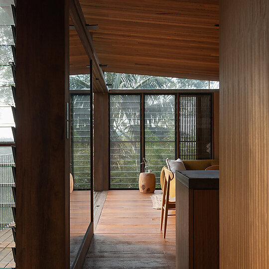 Interior photograph of Bayview Tree House by The use of recycled hardwood enhances the connection to the outdoors. Photographer: Luke Shadbolt