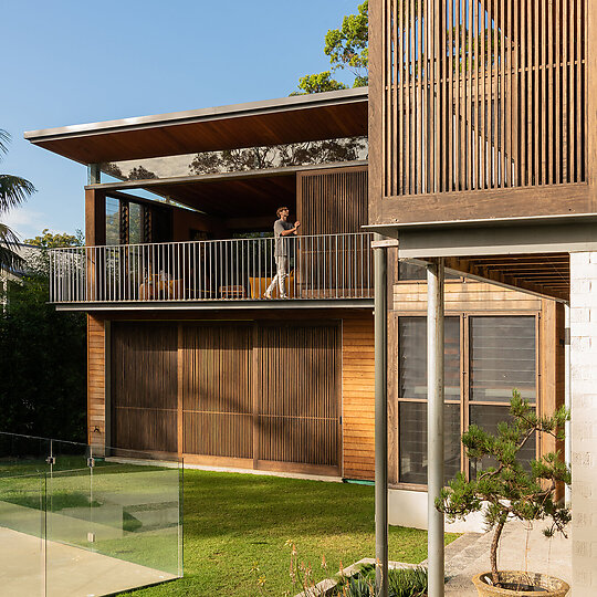 Interior photograph of Bayview Tree House by Sliding timber screens enhance the connection to the outdoors, thermal comfort, cross flow ventilation and tactility. Photographer: Luke Shadbolt